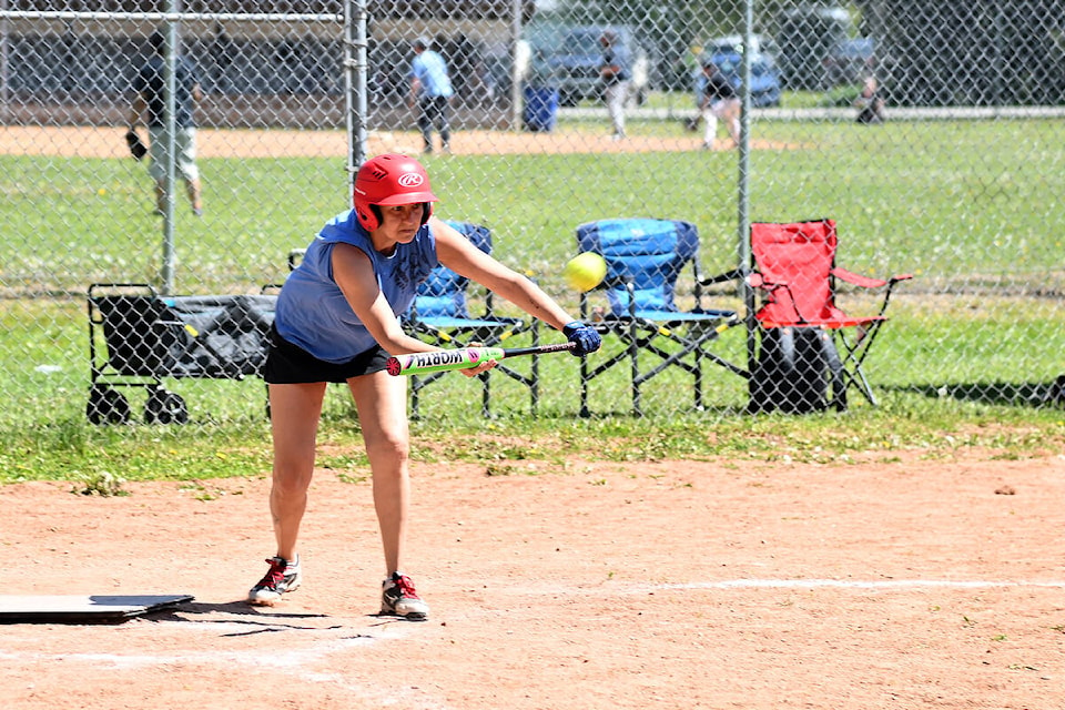 Dirty Jerseys player Lori Watson keeps her eye on the ball as she shortens her stance for a bunt hit during a May Days weekend ball game on Sunday. Seven teams gathered at the Capostinsky Park baseball diamonds over the long weekend from Kamloops, 100 Mile House, Clearwater and surrounding areas. A 50/50 fundraiser during the event raised $615 for Clearwater Minor Ball. (Stephanie Hagenaars/Clearwater Times)