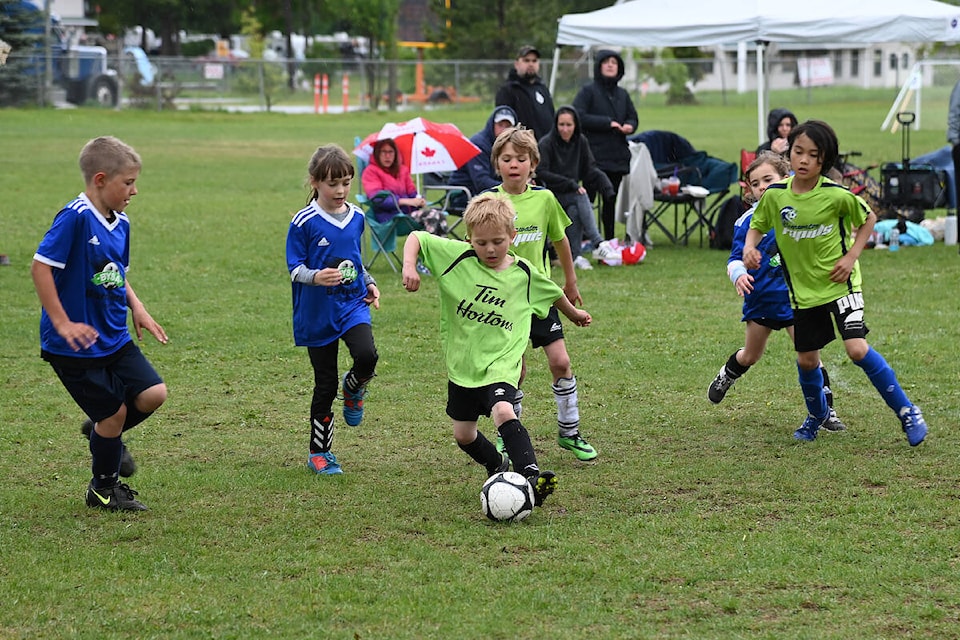 Names/level kicks the ball forward and towards the opposing net for his fellow Clearwater Rapids team during a game on Sunday. The rain fell, but it didn’t stop these excited kids from playing. (Stephanie Hagenaars photo)