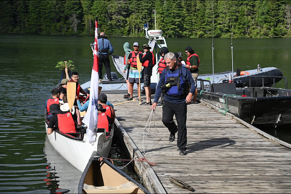 Rod Tulett unties the ropes of the Royal Canadian Navy canoe on Clearwater Lake Tuesday morning (July 19). The canoe is one of 18 in the 20th Pulling Together Canoe Journey. It is the second time the Navy has had a canoe in the event. (Stephanie Hagenaars photo)