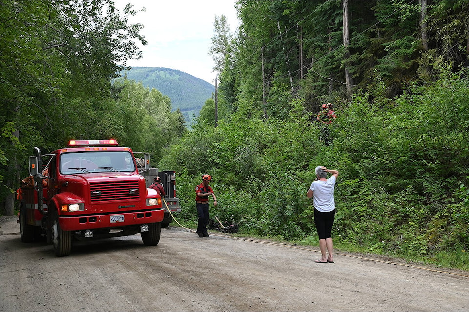 Crews from BC Wildfire pack up after extinguishing a forest fire that sparked Monday evening near Vavenby. A member of the Vavenby Volunteer Fire Department responded to the call, as well as a nearby team from Trans Mountain. Fire Chief Philip Weber said the trees were candling when crews arrived. Early investigations suggest the wildfire sparked when a tree fell onto a power line due to high winds. (Stephanie Hagenaars photo)