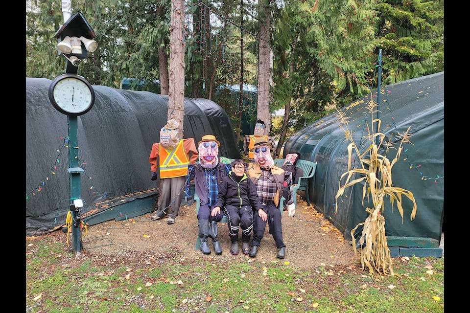 Bev Smith poses for a photograph with the caricature figures she created as part of her Halloween display. (Michelle Johnson/Clearwater Times)