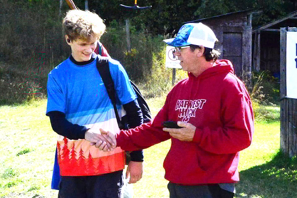 Dylan Erickson (L) of Galiano Island is congratulated by event director Dennis Greffard of Clearwater after winning the 2024 Canadian National Mixed Amateur 1 division during a tournament held in Clearwater last weekend.   
