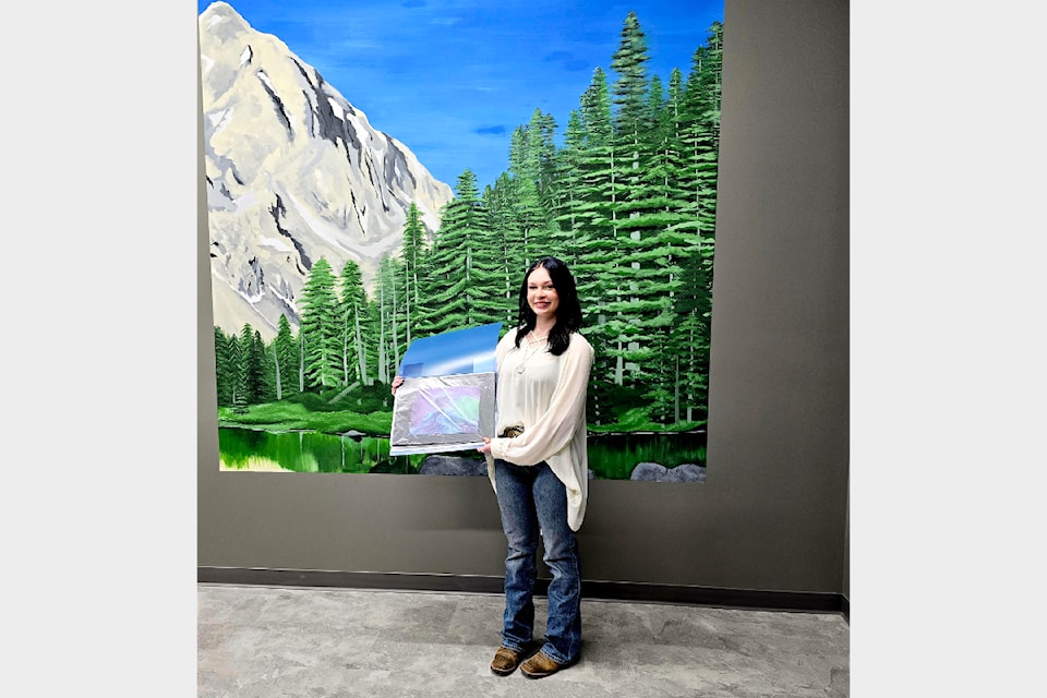 Harmony Trommeshauser, a young local artist, dedicated hours to painting a large mural in the new Lower North Thompson Community Forest offices. 