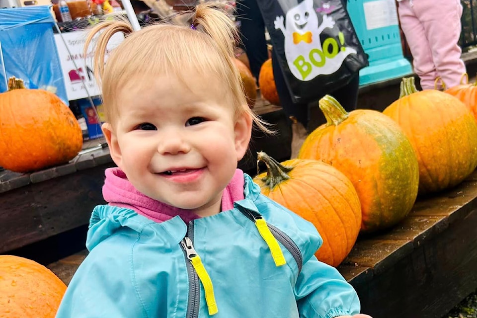 Little Aliya Jade Everard from Clearwater is happy with her pumpkin coloured balloon at the  second annual Royal Lepage Westwin Halloween party on Oct. 20 in Clearwater. 