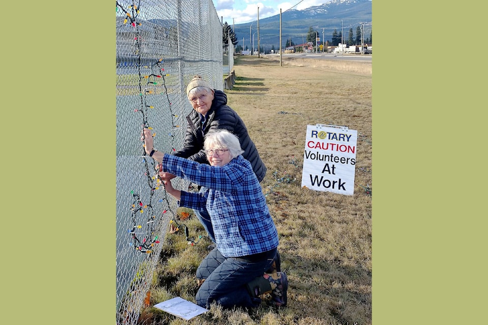 From our archives - Nov. 26, 2017. Clearwater Rotary Club members Jean Nelson (back) and Abby Bates attach strings of Christmas lights to the fences by the tennis courts next to Highway 5 recently. The lights spell out “Merry Christmas’ and “Joyeux Noel.”