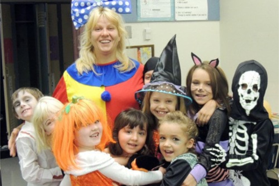 Blue River youngsters give a group hug for Halloween to Christine the Clown.