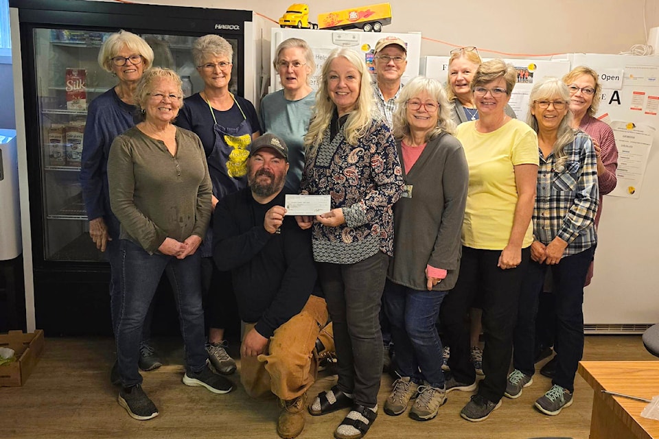 The Clearwater and District Food Bank received a donation of $25,000 from the Clearwater Curiosity Thrift Shoppe on Oct. 3. (lower centre) Neil Broswick accepts the cheque on behalf of the food bank.
