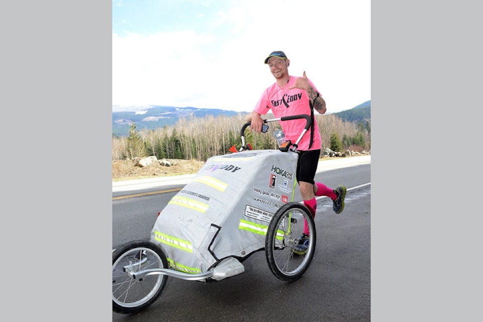 'Fast Eddy' Dostaler gives a Shaka sign of goodwill as he runs along Highway 5 south of Clearwater in March of 2015.