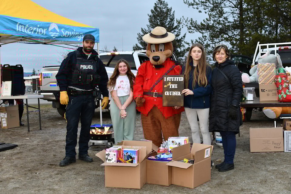 (From L - R): Const. Jeremy, Claire Bourque, RCMP Safety Bear, Isabel Maddocks - Puetz, Michelle Young helping out at the Stuff the Cruiser event on Dec. 5 in Barriere. 