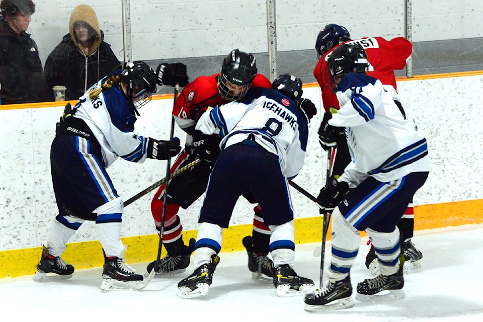 Exciting Clearwater Minor Hockey action. Clearwater U18 IceHawks, Bailey Rotzetter (#4), Austin White (#8), and Blake Irvine (#10) battle for the puck in the game against Chase, at the North Thompson Sportsplex Jan. 25.  