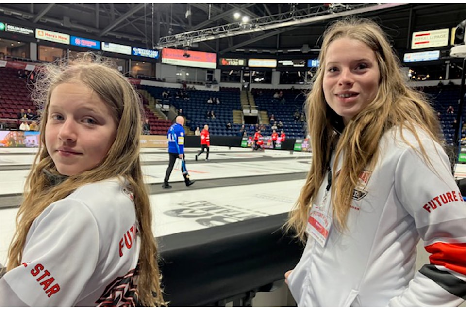 Future curling stars Kate-Ann Ekins (l) and Eva-Mae Ekins from Barriere during warm-up at the recent Montana's Brier in Kelowna.
