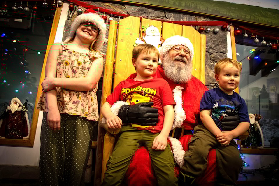Clearwater kids, Aurora, Hugh and Norman (From L - R) with Santa at the Dec. 1 Rotary Christmas Tree Light up on Sunday. 