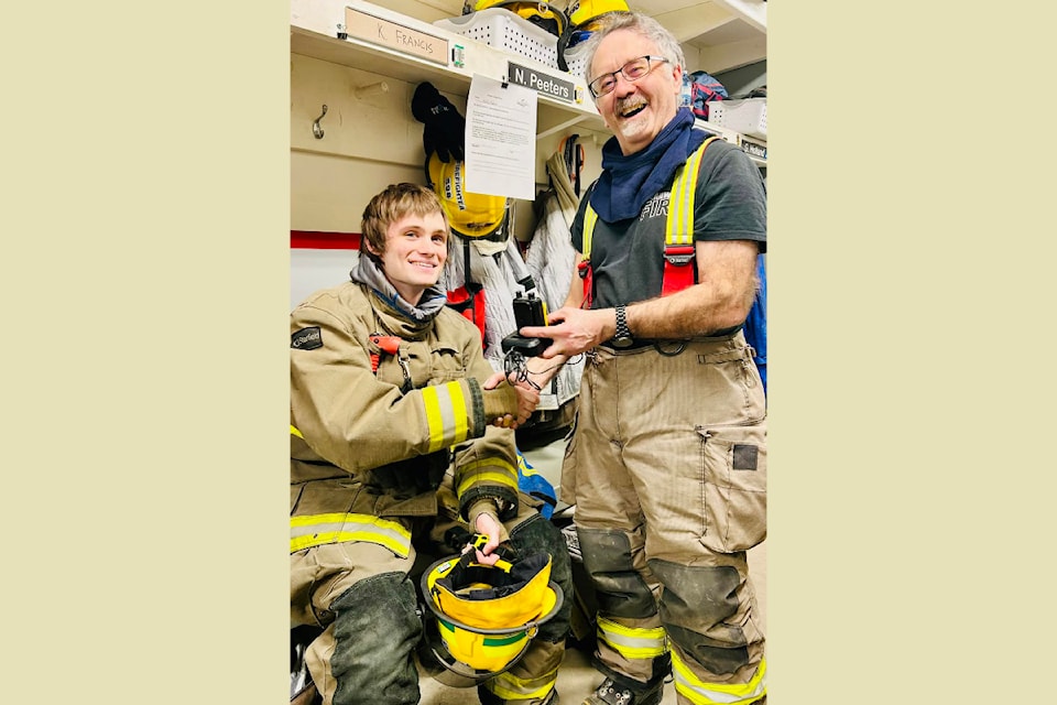 Clearwater Fire Department trainee, Kolby Francis receives his pager as a promotion from deputy chief, Guy Holland on January 31 at the Clearwater Firehall. 