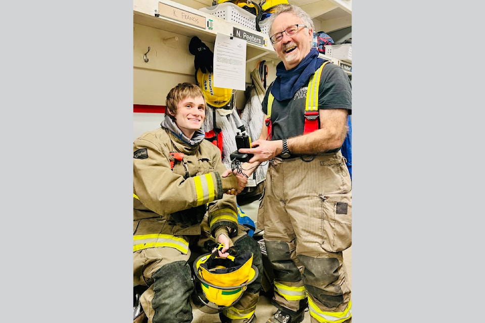 Kolby Francis (Left) of the Clearwater Fire Department is presented with his newly earned pager by deputy fire chief, Guy Holland. 