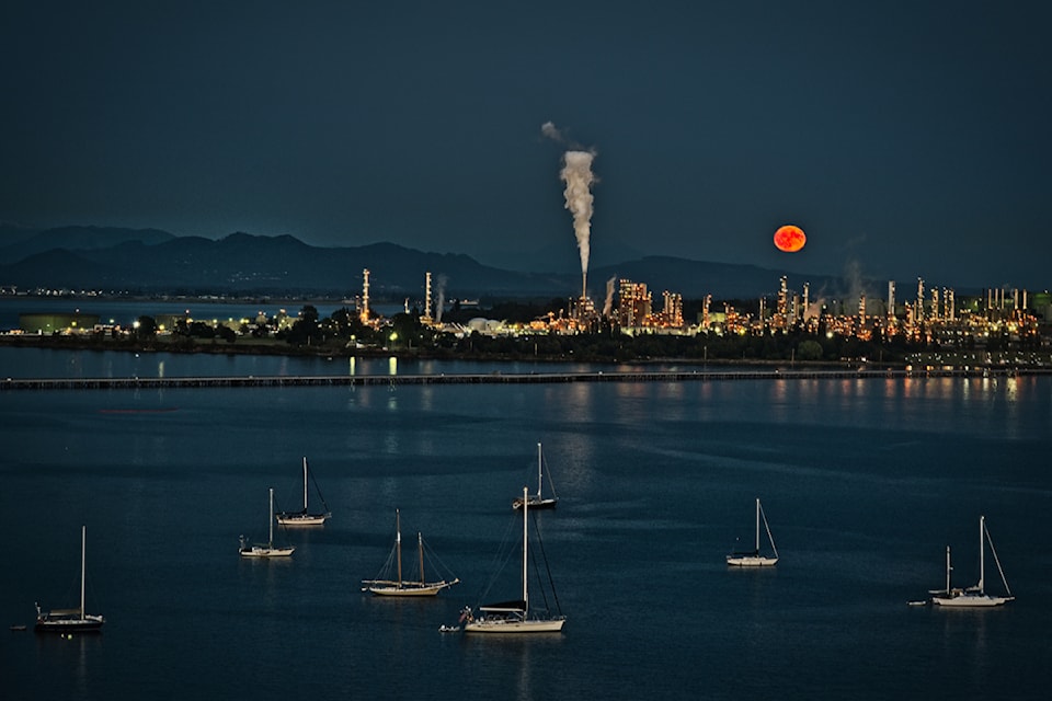 Bright orange moon rise over  Fidalgo Island in July. 