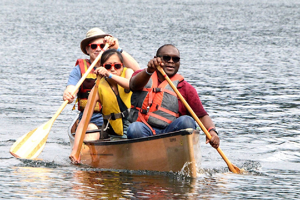(From L - R): Dr. John Soles, fourth year medical student Joanne Kwan and Dr. Kayode Bamigboje paddle in a canoe race - a first time experience for Kwan and Dr. Kay. They were taking part in the Clearwater Canoe Regatta in September 2018.