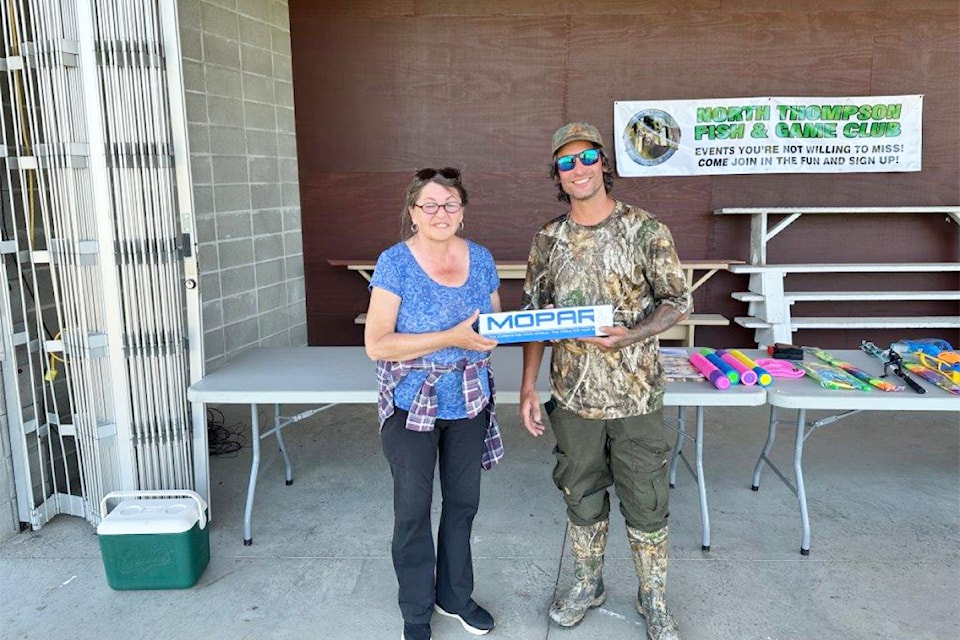 Receiving the participant for the 'Furthest Away' prize in the North Thompson Fish and Game Club Father's Day Fishing Derby on June 15 was winner, Pierre Asselin from Penticton. (From L - R): Organizer Kathy Campbell presenting to Pierre Asselin. 