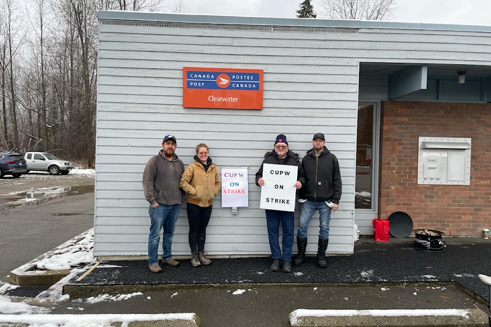 Four striking postal workers outside the post office in Clearwater, B.C. in November, 2024. The TNRD advises residents to use e-billing during the ongoing strike. 