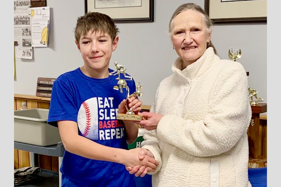 (Right): Theresa Robinson from BCC presents (Left): Corbin Summers with Sportsmanship trophy on March 15 during the 2025 Jam Can at the Barriere Curling Club.