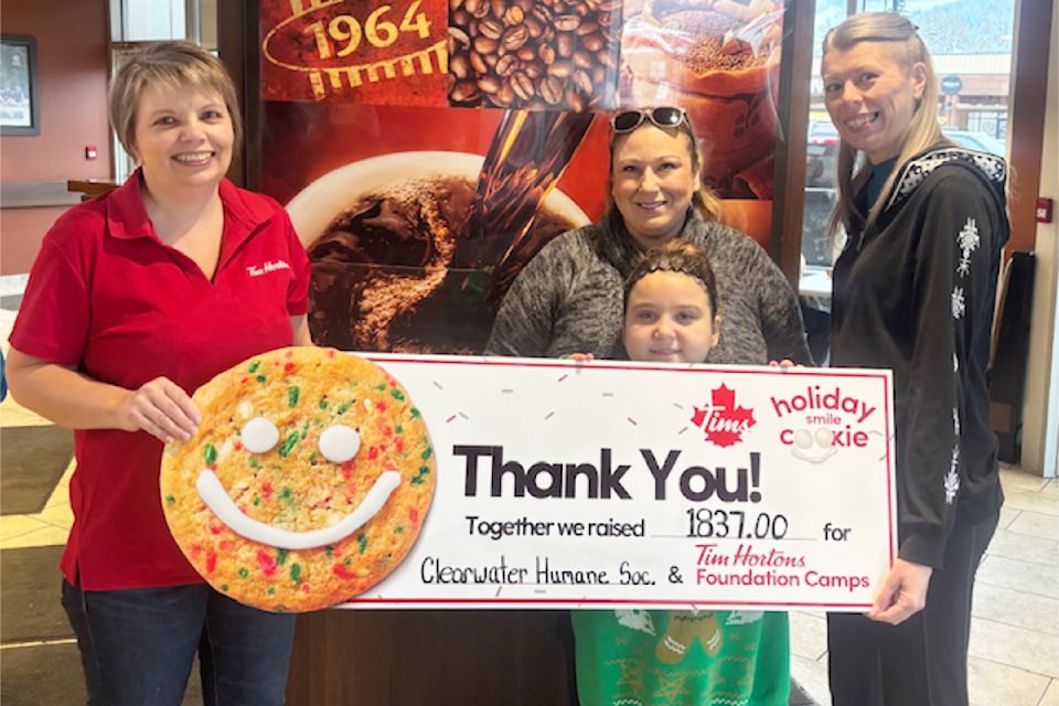Laura Olivier, Owner of Clearwater Tim Hortons, (left) presents Maddy Beka (center) with her daughter, Shylo Ryde, and Rowan Borneman of the Clearwater Humane Society, a cheque totalling 1837.00. The total funds raised will be shared with the Tim Hortons Foundation Camps. Each charity will receive 918.50.