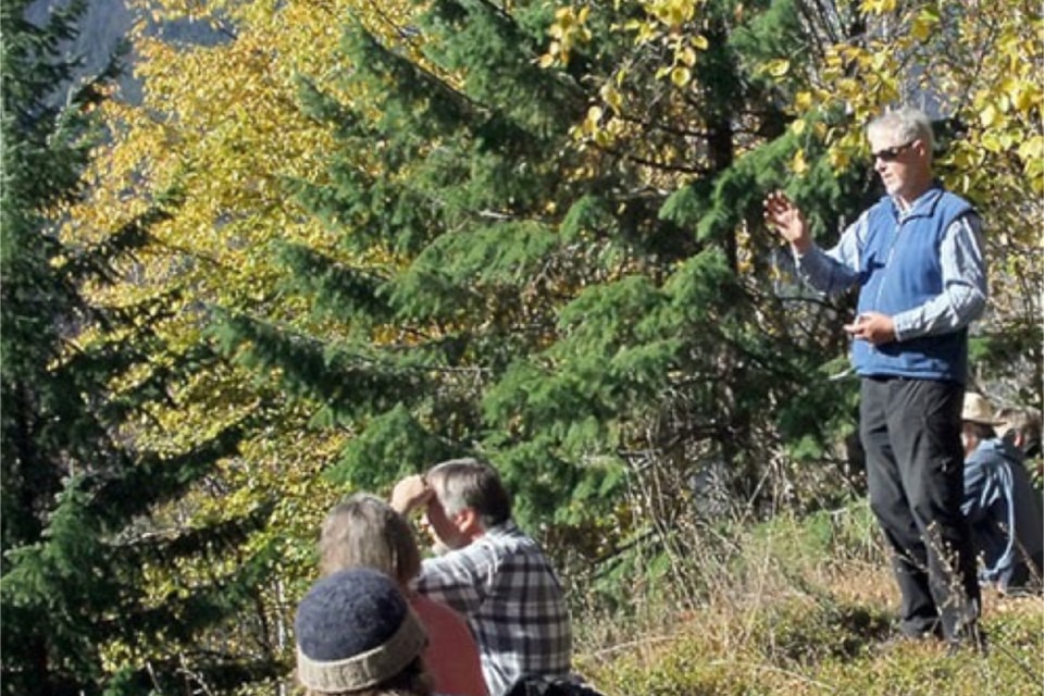 Trevor Goward (r) makes a characteristic gesture as he gives a talk during a recent hike along the trails betweeen First and Third Canyons.