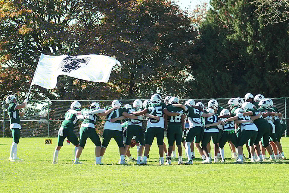 Logan Ginther waves the LT flag while the Panthers give themselves a pep talk ahead of their game against STM Oct. 12.