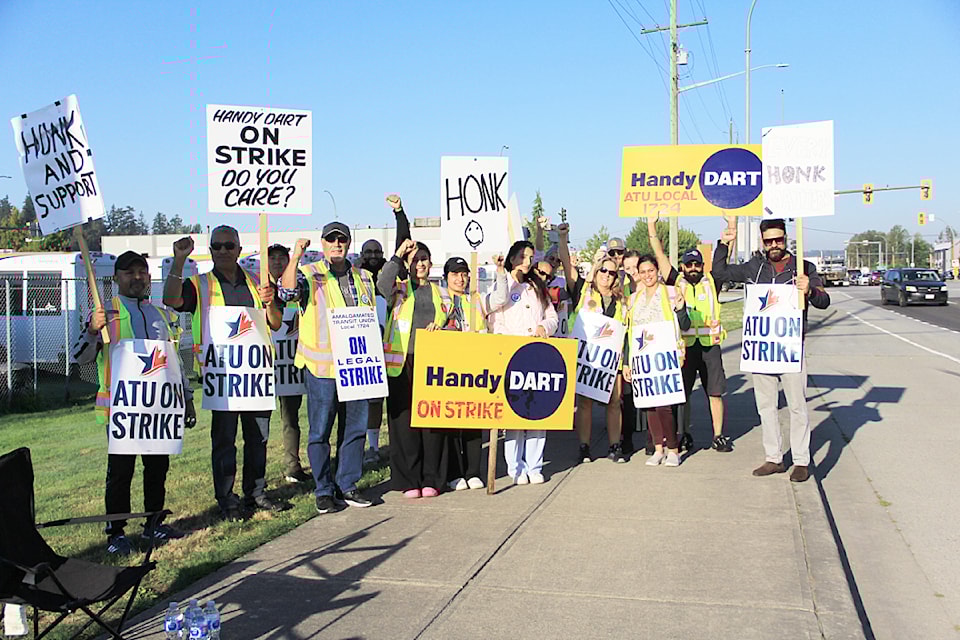 Members of Amalgamated Transit Union, Local 1724, picket outside HandyDART's Cloverdale depot Sept. 5.