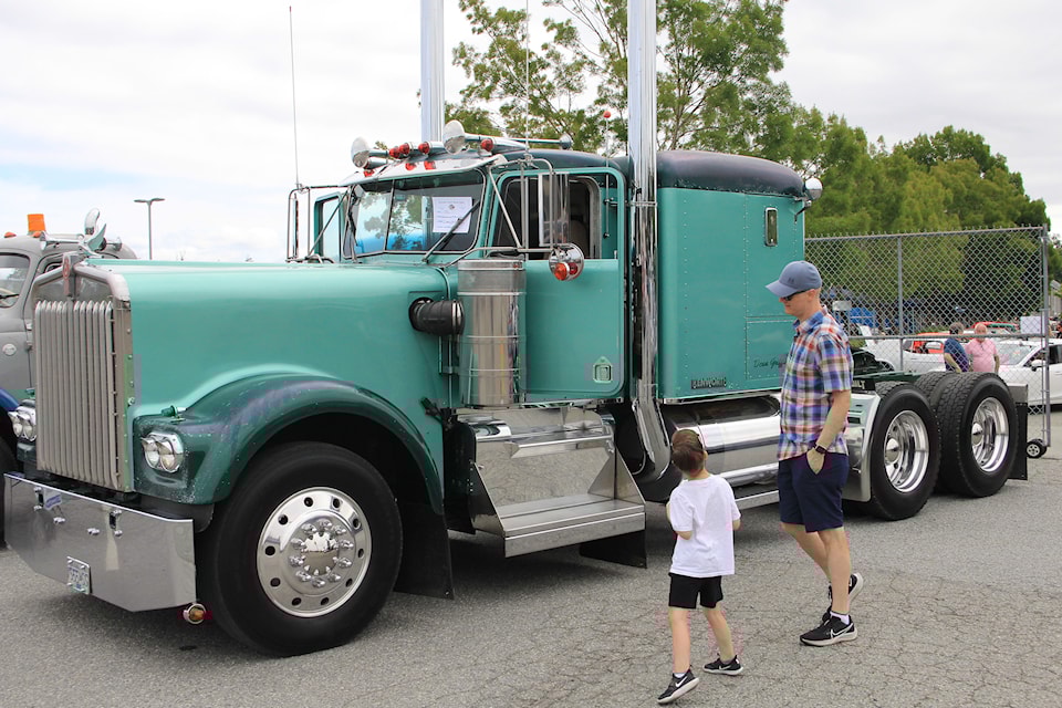 Show-goers inspect a 1981 Kenworth at the National Truck Show, held July 5 at the B.C. Vintage Truck Museum.