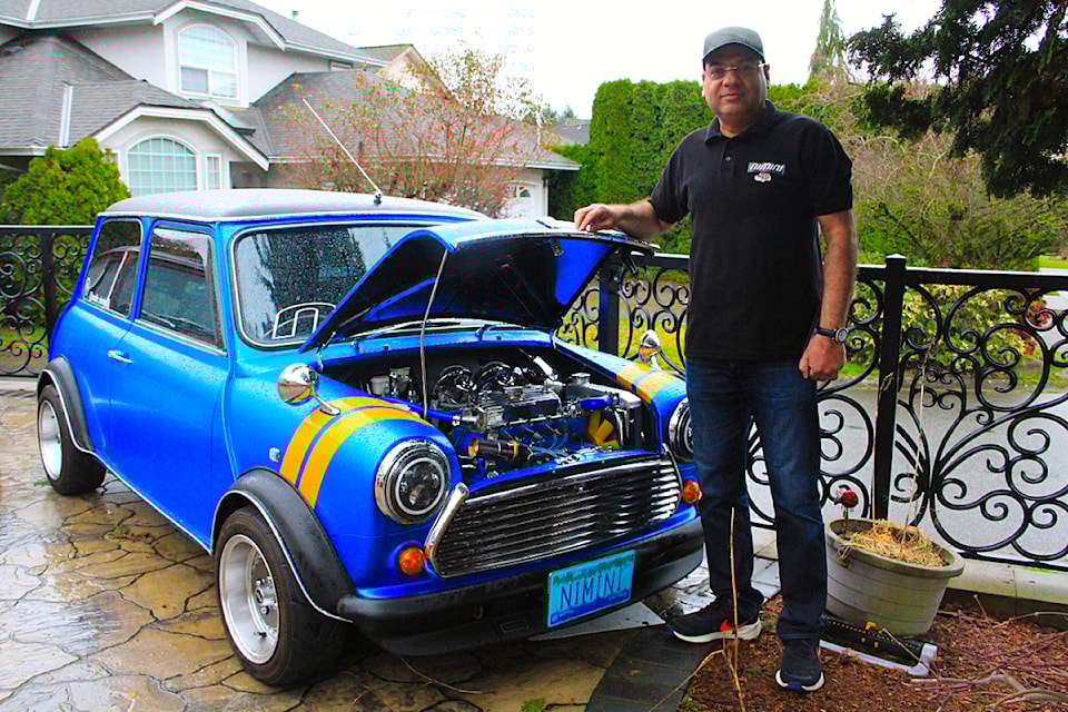 Cloverdale's Nadir Ibadullah stands beside one of the 16 Minis he owns.