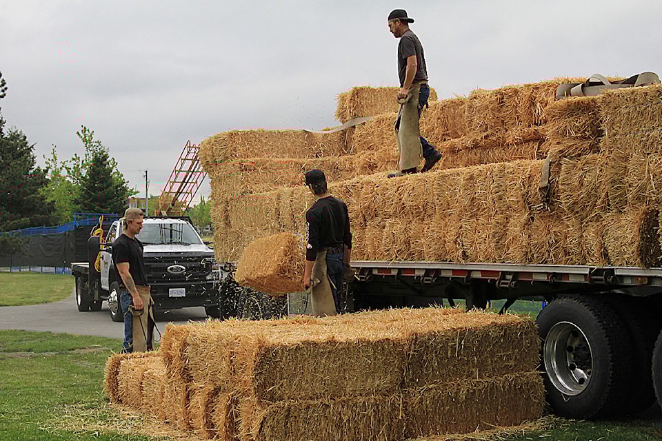 Workers from Vanderveen Hay Sales stack bales on the Fairgrounds ahead of the 2025 Cloverdale Rodeo and Country Fair. The rodeo and fair will be held May 16-19 on the Cloverdale Fairgrounds.