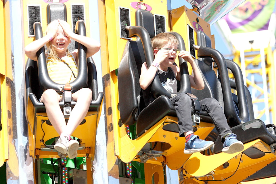 Siblings Kylie and Landyn Pasemko of Vernon go for a thrill ride on the Super Shot at the midway during the IPE in Armstrong, which continues through to Sunday, Sept. 1 (Jennifer Smith - Morning Star)