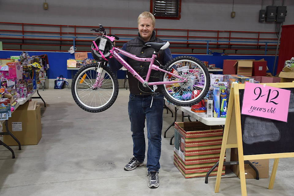 Cloverdale Christmas Hamper Program organizer Matthew Campbell stands with a donated bike in 2018. This year’s hamper program has officially begun and Campbell says the whole program is based on the generosity of the Cloverdale community as the initiative relies on donated food, gifts, and money. (Black Press Media File Photo)