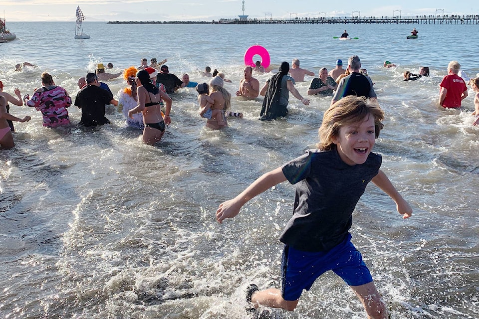 Zapped by the cold, Colby Walker runs from the water at the White Rock Polar Plunge. (Christy Fox photo)