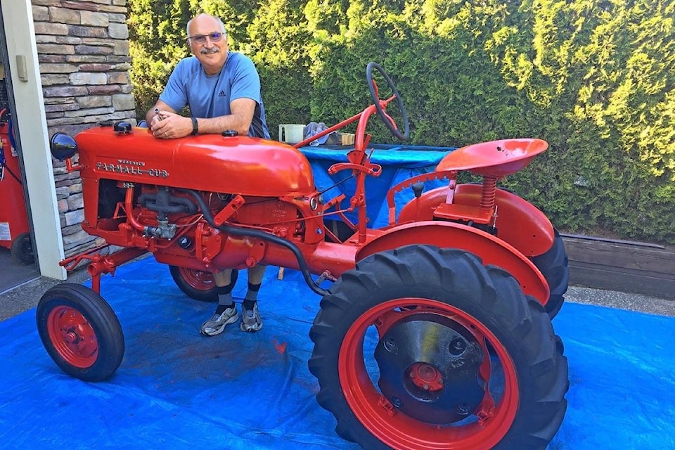 Ron Henze with the 1956 Farmall Cub he restored for his best friend’s father. (Contributed photo)