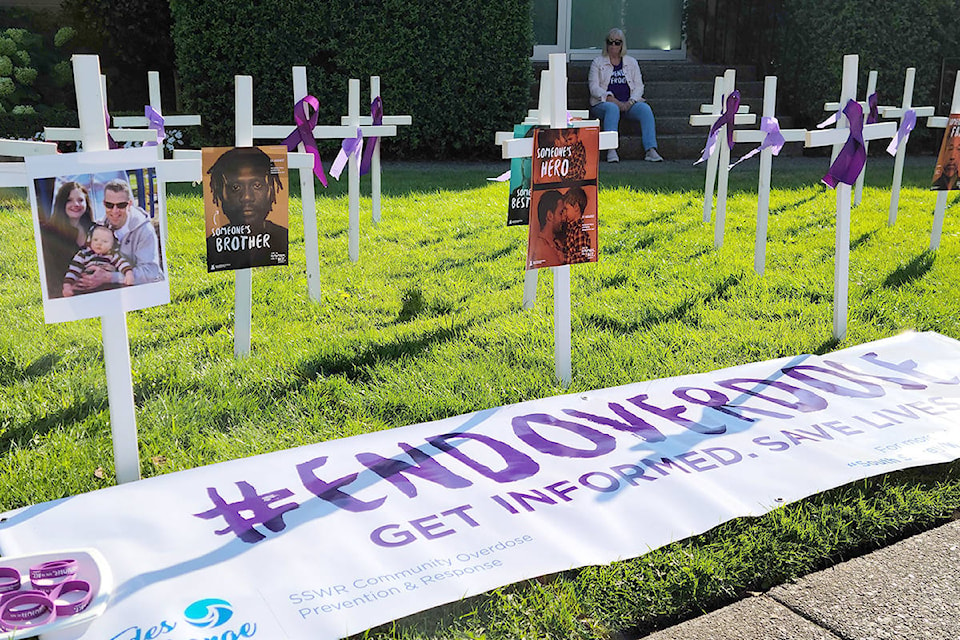 White crosses adorned with purple ribbon outside White Rock City Hall mark International Overdose Awareness Day Monday. (Nick Greenizan photo)