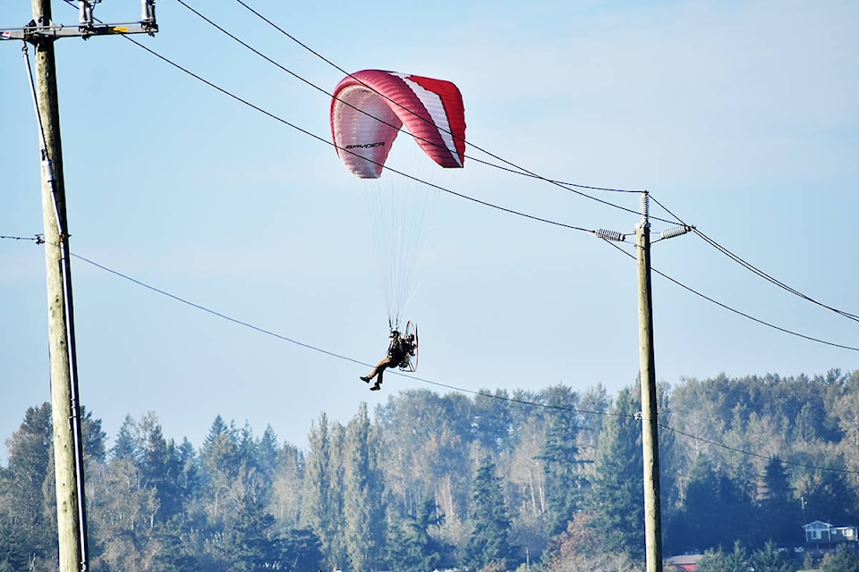 A paraglider cruises over farmland in South Surrey, near 8 Avenue and Highway 15, Monday afternoon. (Aaron Hinks photo)