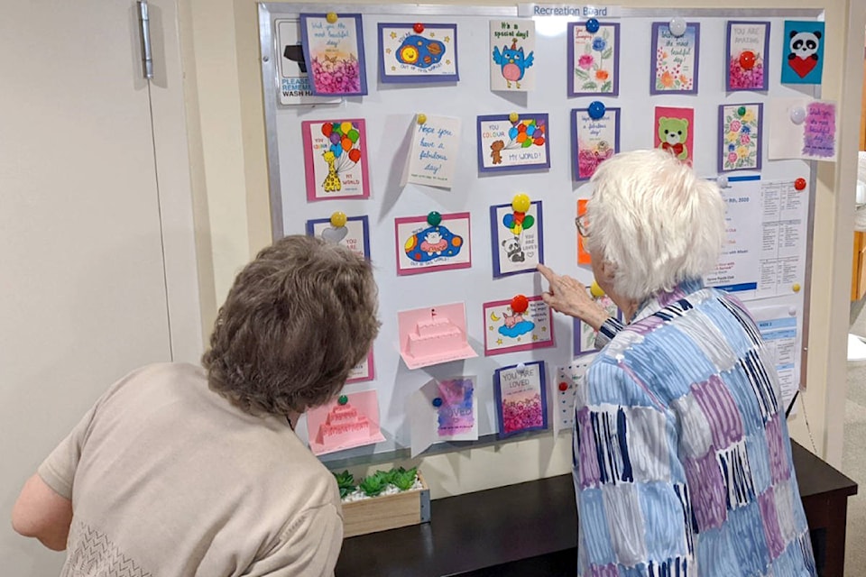 Photos taken by staff at Langley Seniors Village show admirers of handmade cards created by R.E. Mountain Secondary students and other volunteers for local seniors who are isolated due to pandemic restrictions. (Alice He/Special to Langley Advance Times)