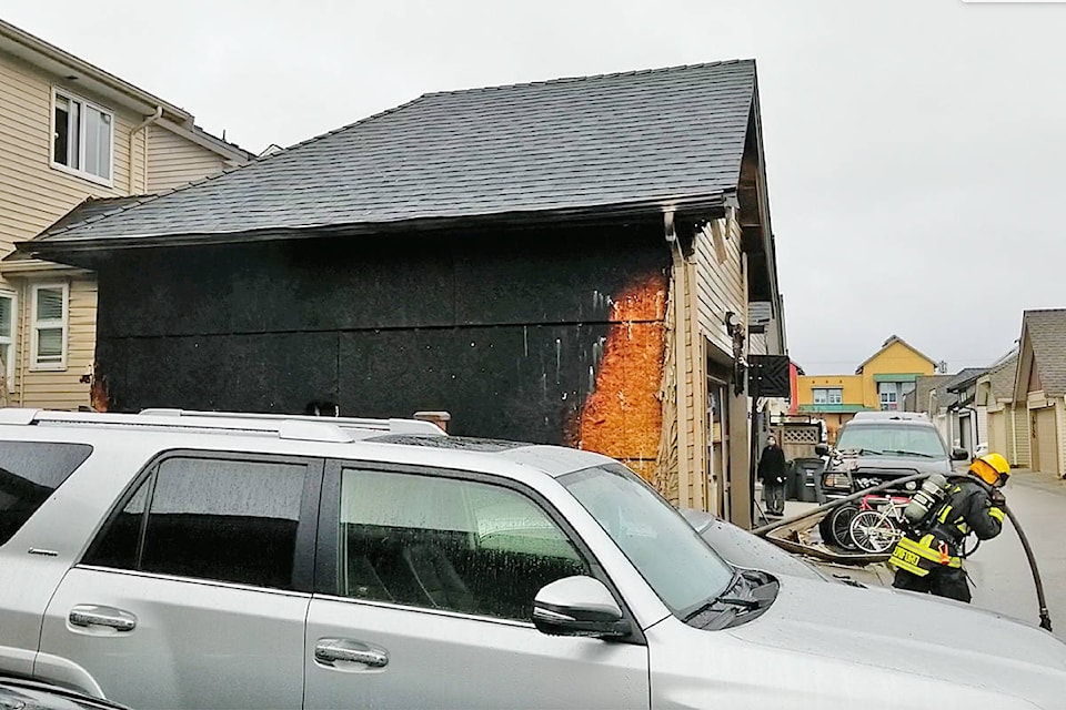 Firefighters and police responded to a fire that damaged a garage near 192nd Street and 72nd Avenue Saturday morning (Dan Ferguson/Langley Advance Times)
