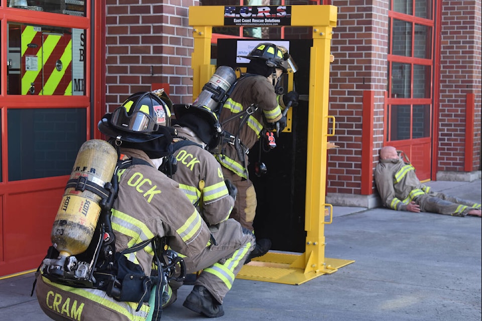 White Rock firefighters prepare to force open their new training door, while mannequin ‘Rescue Randy’ waits to be saved, during an April 27 demonstration training exercise at the fire hall. Alex Browne photo