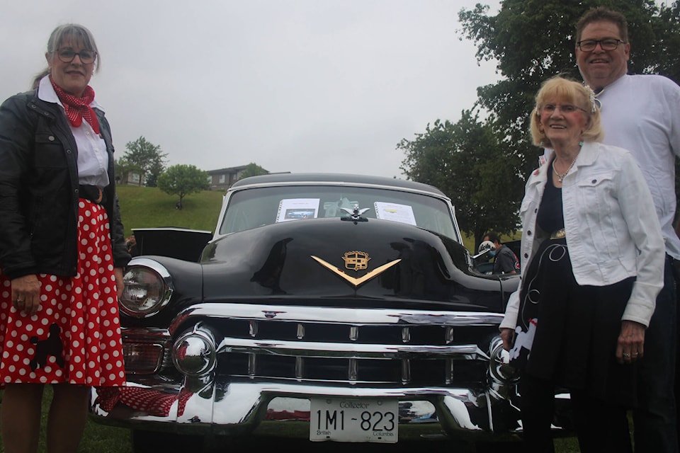 From left to right: Kelly Ridley, Joyce Nadeau and Lorne Ridley standing next to the 1953 Cadillac Fleetwood Sedan, dressed in 1950s-style attire. Patrick Penner / Mission Record