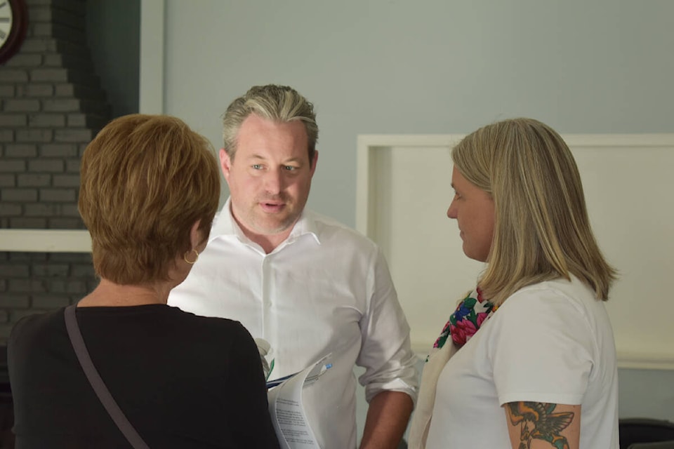 Surrey-White Rick MLA Trevor Halford and Surrey South MLA-elect Elenore Sturko talk with a resident following the town hall meeting. Alex Browne photo