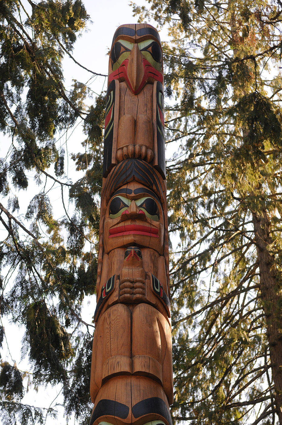 This totem pole was rededicated to the late Chief Richard Malloway outside the Cultus Lake Park Board office on Tuesday, Sept. 20, 2022. The top figure is a raven representing the late Chief Richard Malloway. The second one is a woman holding a baby eagle representing the Cultus Lake Park Board. (Jenna Hauck/ Chilliwack Progress)