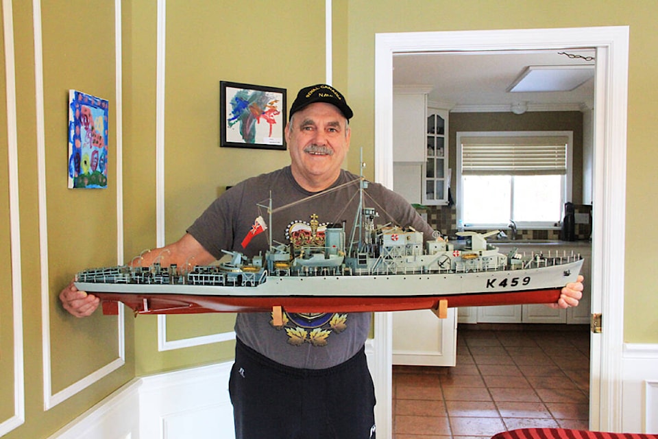 Yvon Lehoux holds a model of the HMCS Thetford Mines, a ship he built by hand. (Photo: Malin Jordan)