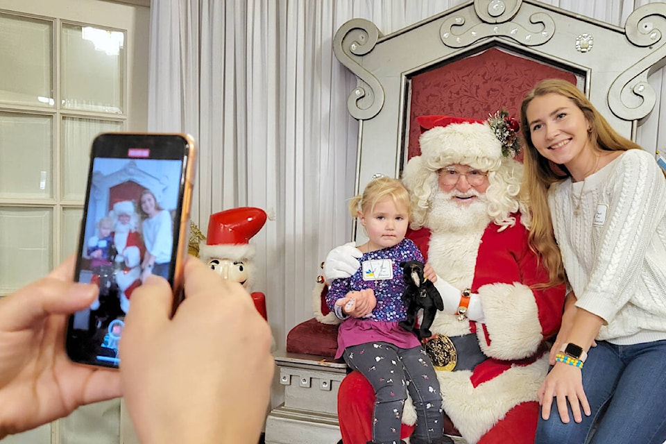 Two-and-half-year-old Taisiia Zhulin and her mom Zhulina posed with Santa at a special Ukrainian Christmas event at Newlands Golf and Country Club in Langley City on Saturday, Jan. 7. (Dan Ferguson/Langley Advance Times)
