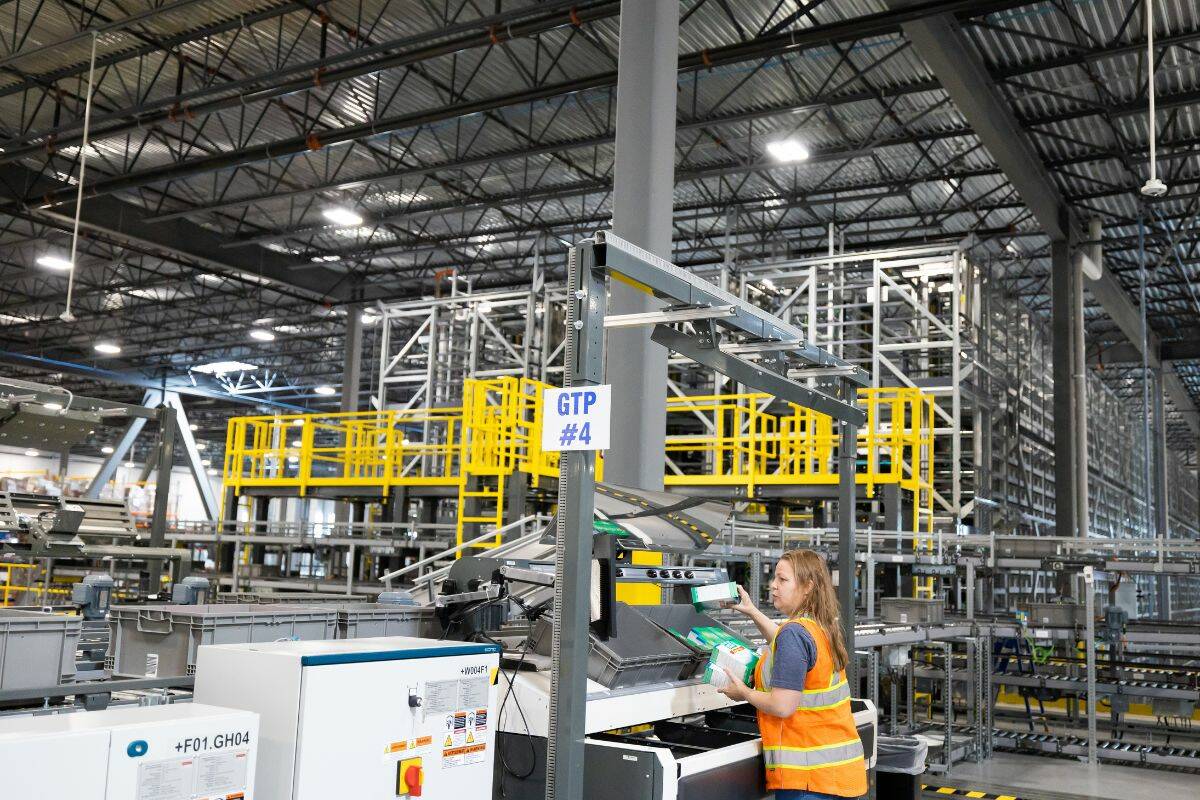 Over 50,000 orders are processed every night, which amounts to over 255,000 units. About 40 per cent of that goes through the goods to person area (pictured above). The products come to employees in grey bins. The employee will pick up the product and place it in the red bins and move along the automated line.