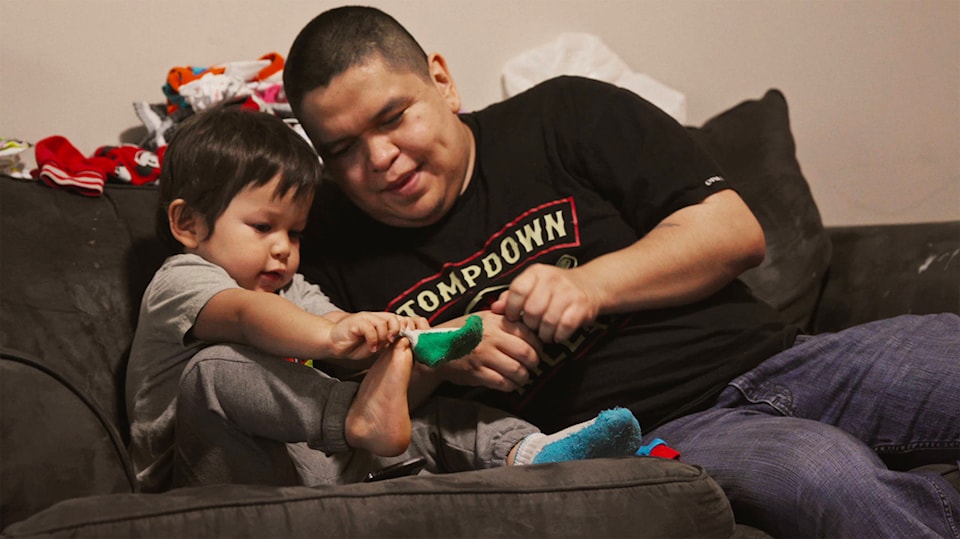 22845057_web1_radio_host_qxta_helps_get_his_son_ready_before_leaving_to_work_at_nuxalk_radio-copy