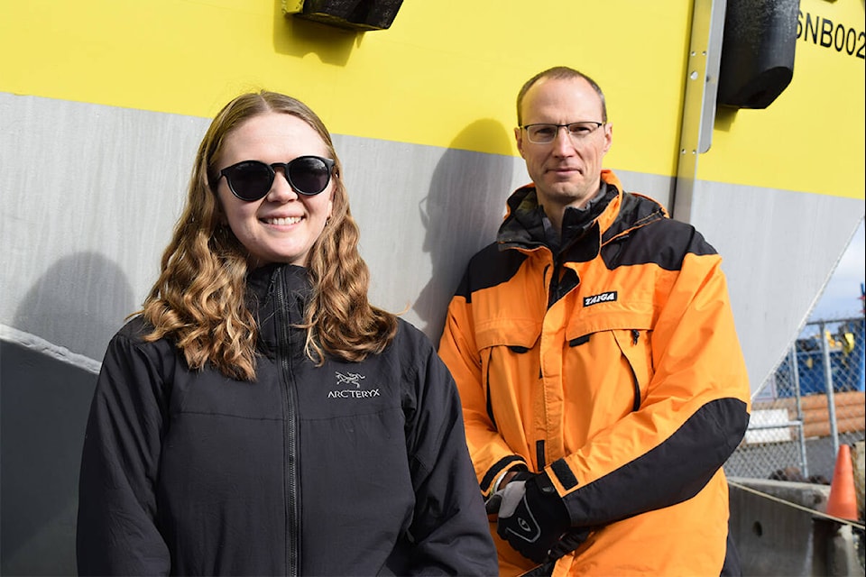 Scientists Chloe Immonen and Curran Crawford with the University of Victoria-based Pacifical Regional Institute for Marine Energy Discovery stand with their group’s state-of-the-art wind measurement buoy, Nov. 10 in Victoria. (Kiernan Green/News Staff)