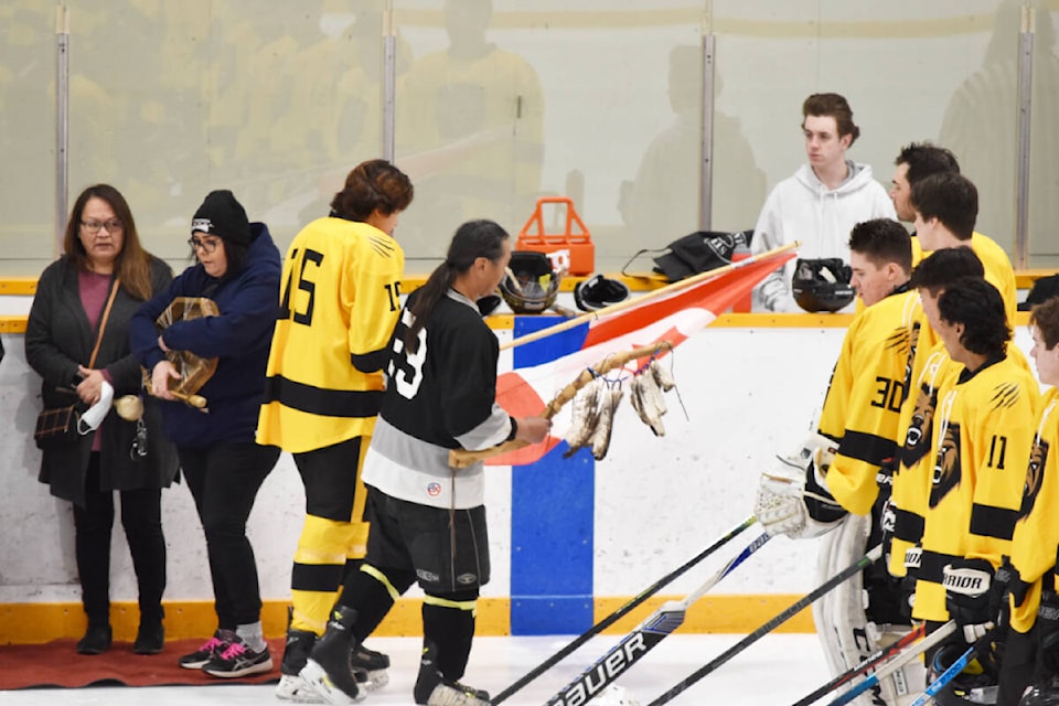 A fundraiser hockey game for the family of the late Todd Sterritt, held March 17, saw the Chilcotin Grizzlies player Jimi Belleau carry a flag and Alkali Braves player Robert Alec Paul and Chilcotin Grizzlies play for fun. (Monica Lamb-Yorski photo - Williams Lake Tribune)