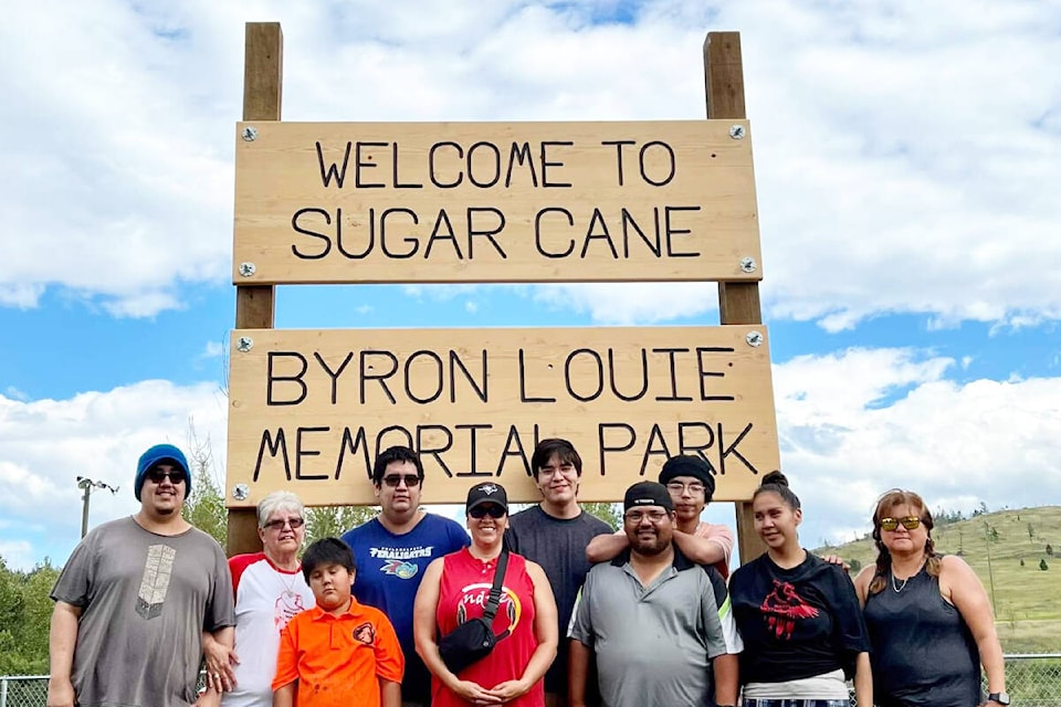 The family of the late Byron Louie gathered for the unveiling of a new sign at the Sugar Cane Ball Diamond where the park was renamed in his honour on Saturday, Aug. 13. (Photo submitted)