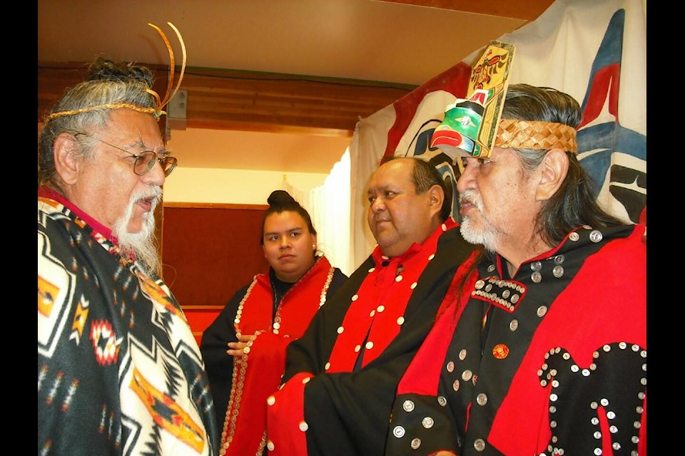 Haa’yuups (Chief Ron Hamilton) from Nuu-chah-nulth speaks with Pa’o (Grayland Hall), Gupshulipis (Chief David Shaw) and Hima’as Ceqweecas (Chief Richard Walker) all from Hanaksiala (Kitlope) during a recent Potlach in Bella Coola. (Sage Birchwater photo)